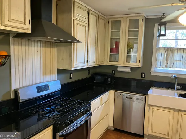 a kitchen that has a sink and a stove