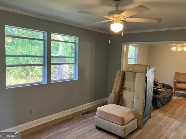a room with a window and chandelier