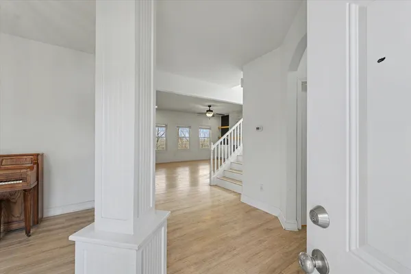 a view of entryway and hall with wooden floor