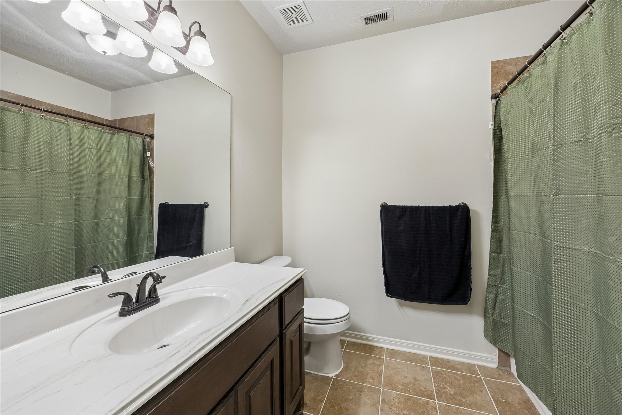 1741 Eagle Lake Road Sealy, TX 77474 - Photo 12 of 15 a bathroom with a sink a toilet and shower