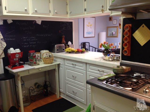 1225 South Rice Road, Unit 49 Ojai, CA 93023 - Photo 14 of 20 a kitchen with a stove and cabinets
