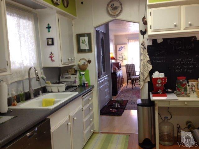 1225 South Rice Road, Unit 49 Ojai, CA 93023 - Photo 15 of 20 a kitchen with sink stove and cabinets