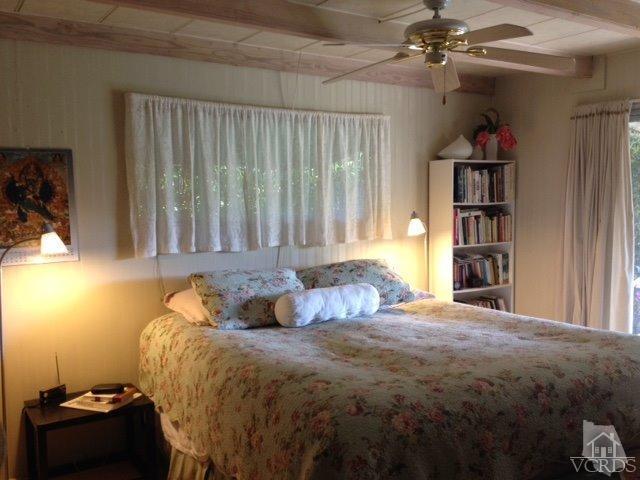 1225 South Rice Road, Unit 49 Ojai, CA 93023 - Photo 17 of 20 a bedroom with a bed and a book shelf