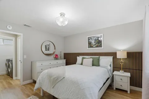 a bedroom with a bed and wooden floor