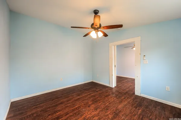 a view of a room with wooden floor and white walls