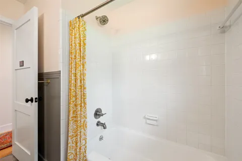 a bathroom with a bathtub and shower