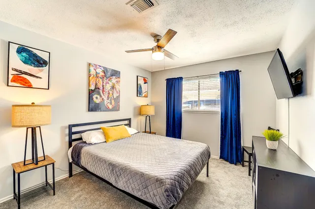 a bedroom with a bed and a flat screen tv