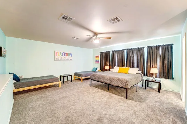 a living room with furniture pool table and projector