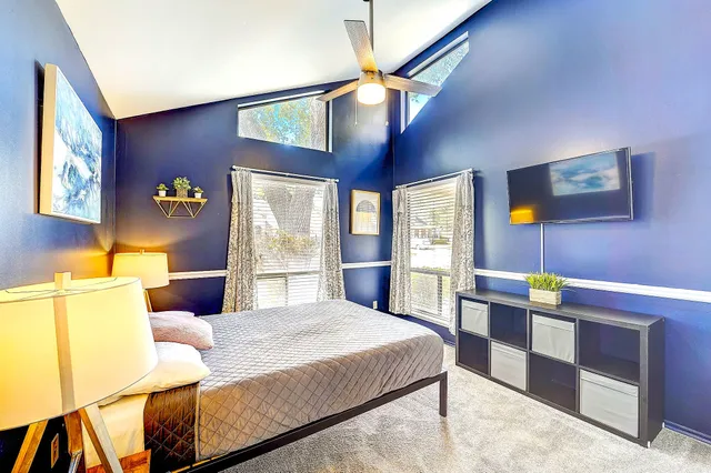 a bedroom with a bed and a chandelier