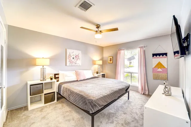 a bedroom with a bed and a flat screen tv