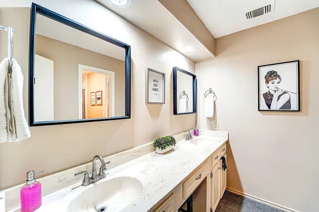 a bathroom with a granite countertop sink a mirror and a