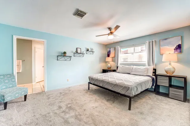 a spacious bedroom with a bed and window