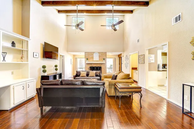a living room with fireplace furniture and a flat screen tv