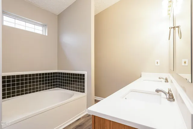 a bathroom with a bathtub and shower