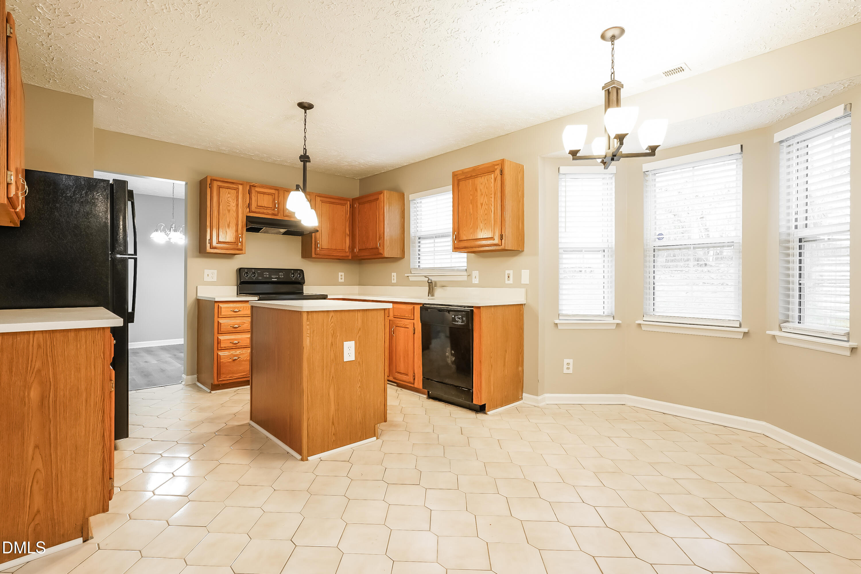 1132 Penselwood Drive Raleigh, NC 27604 - Photo 6 of 17 a kitchen with stainless steel appliances granite countertop a stove a sink a refrigerator and cabinets