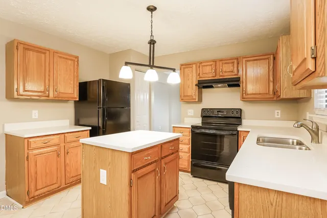 a kitchen with stainless steel appliances a refrigerator stove and sink