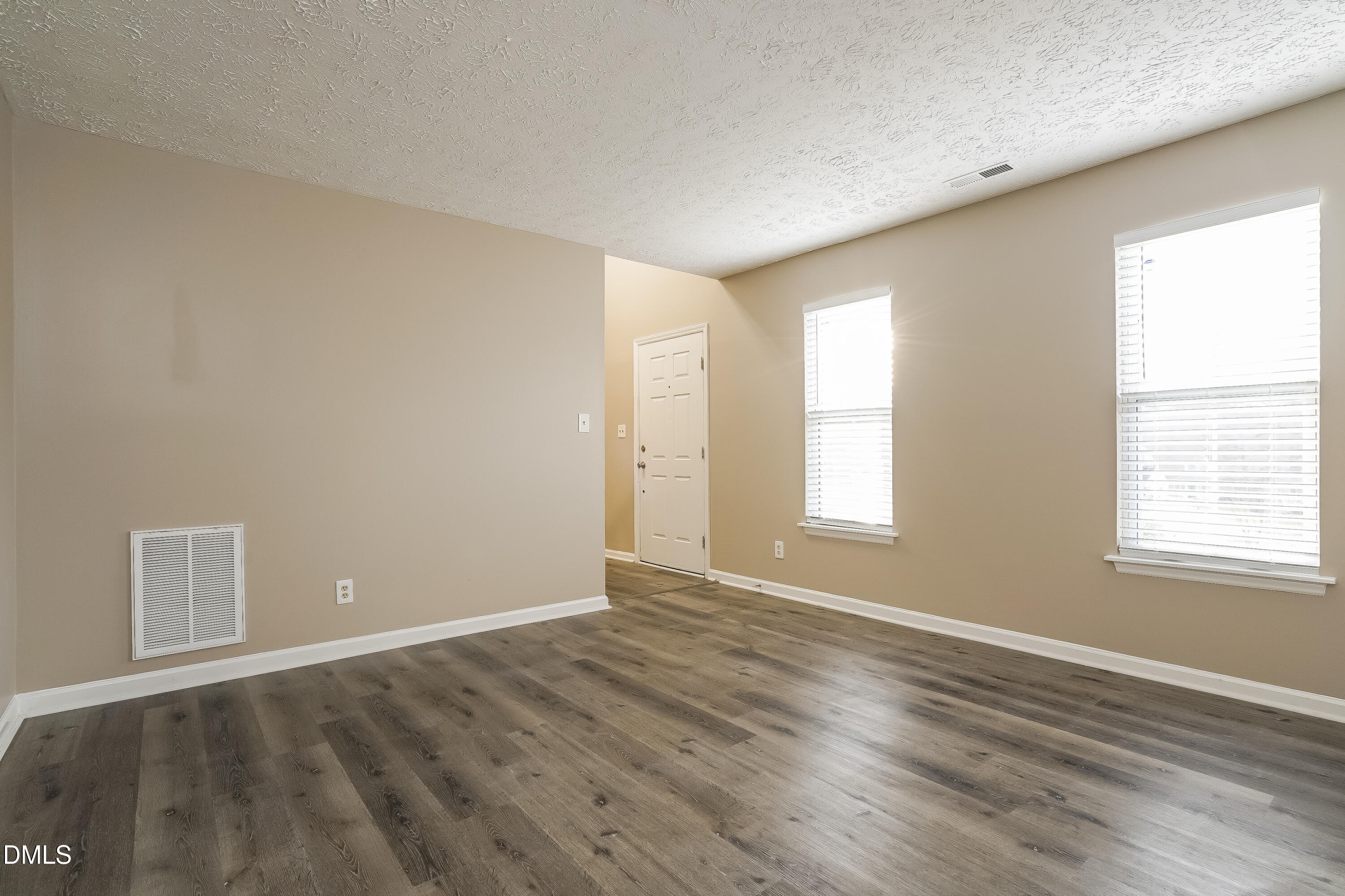 1132 Penselwood Drive Raleigh, NC 27604 - Photo 8 of 17 an empty room with wooden floor and windows