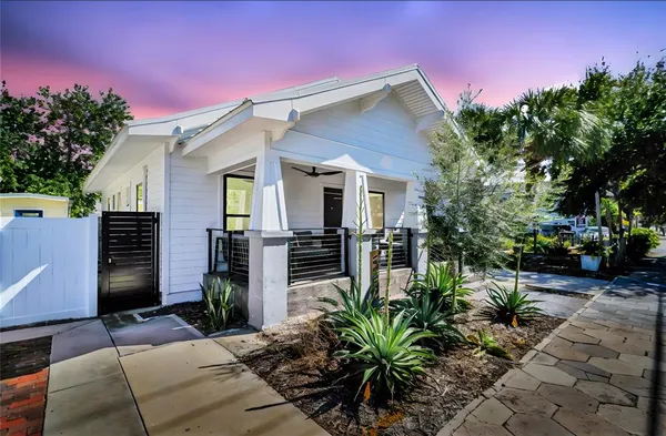 a view of a house with backyard and sitting area