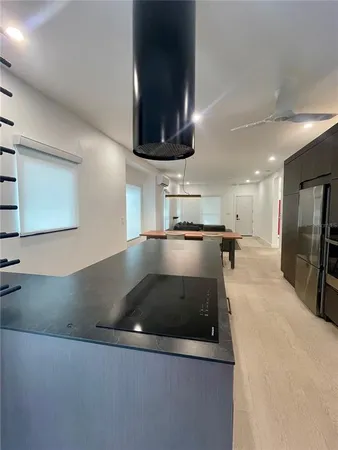 a view of a kitchen with a sink and a stove top oven