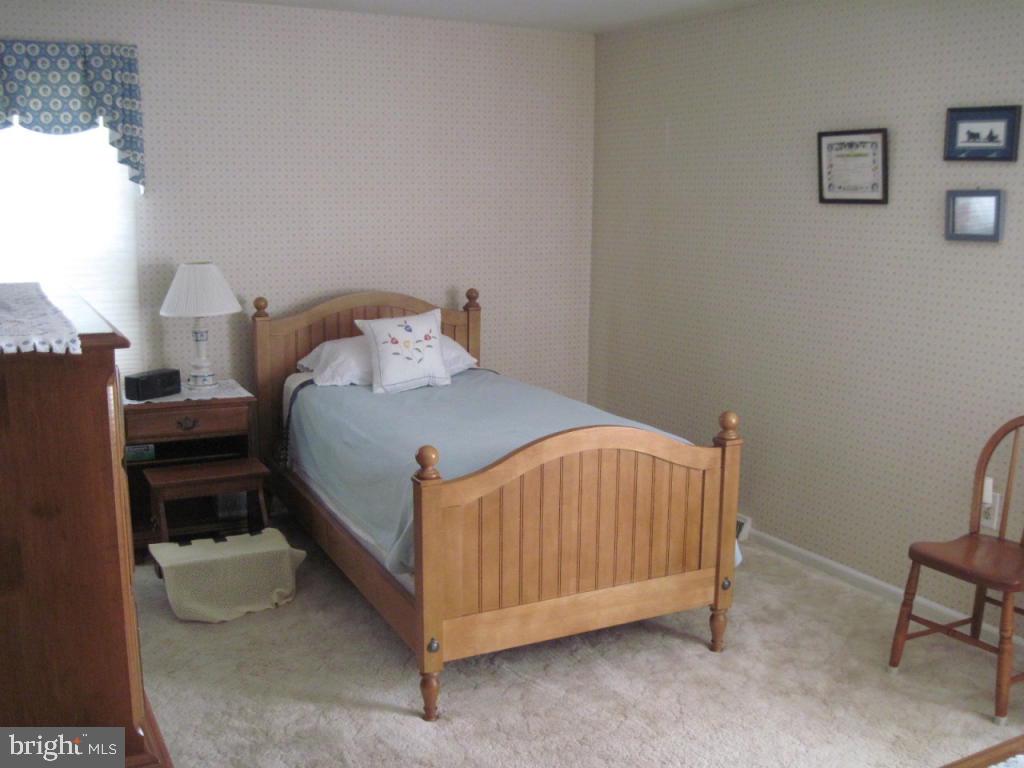 464 Longmeadow Road Lancaster, PA 17601 - Photo 8 of 17 a bedroom with a bed and a chair in it
