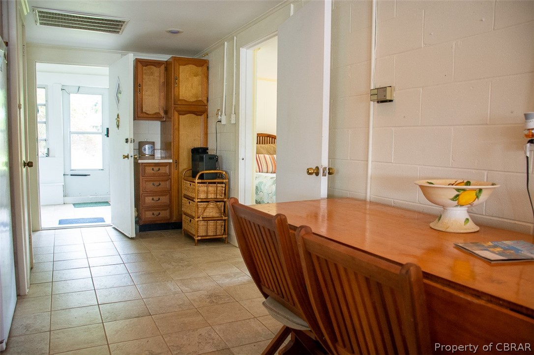 368 Risby Town Road Hudgins, VA 23076 - Photo 22 of 49 View back from great room to entry door and front porch (contains a powder room, 2nd refrigerator, storage and seating area.