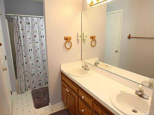 2809 Girth Lane Raleigh, NC 27603 - Photo 6 of 10 a bathroom with a sink toilet and shower
