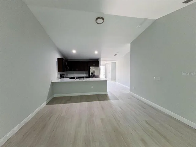 a view of kitchen with cabinets and wooden floor