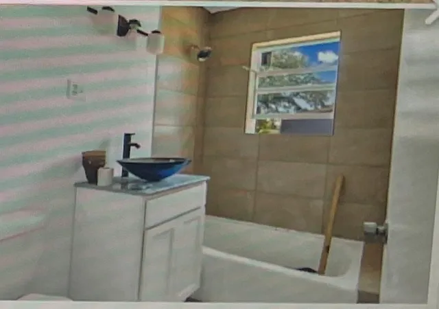 a bathroom with a bathtub and shower