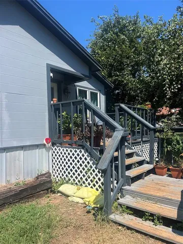a view of deck with wooden fence and trees