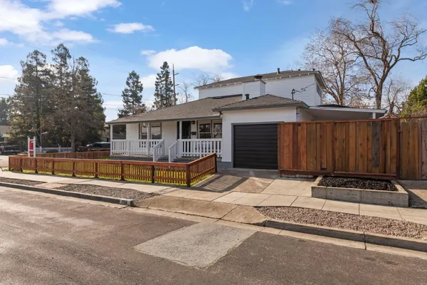 a view of house with outdoor space and sitting area