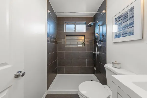 a bathroom with a toilet and a shower
