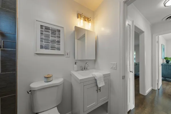 a bathroom with a sink toilet and mirror