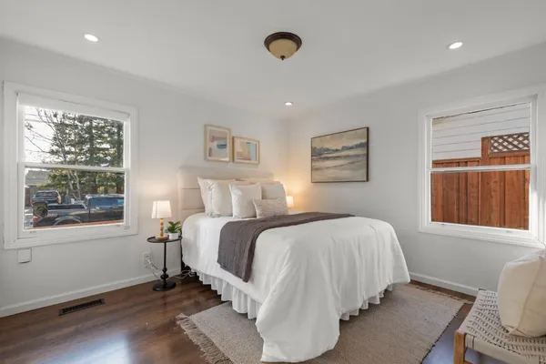 a bedroom with a bed and a window