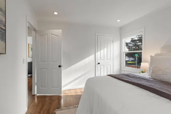 a bedroom with a large bed and a window