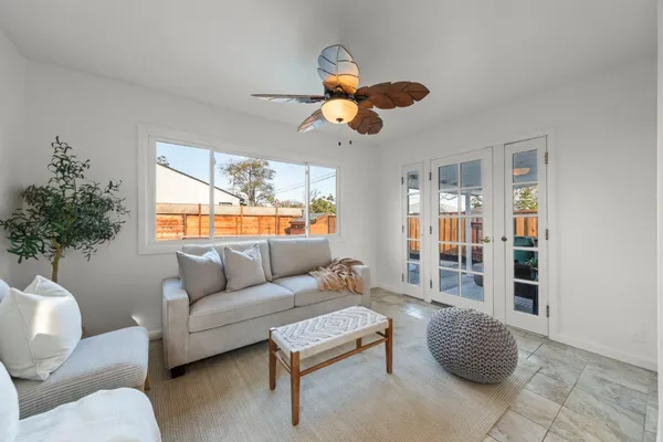 a living room with furniture and a chandelier