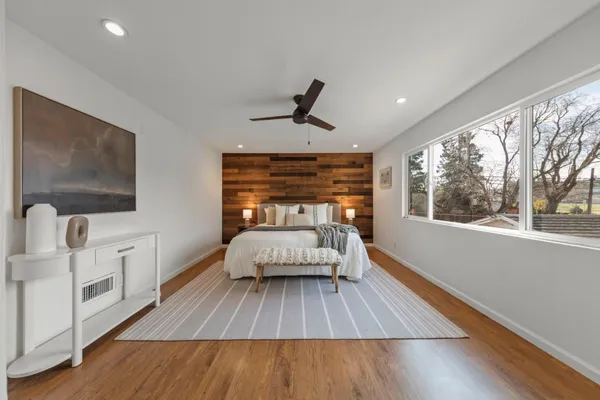 a bedroom with a bed and wooden floor