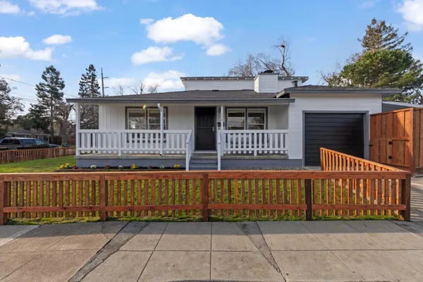 a view of a house with wooden fence