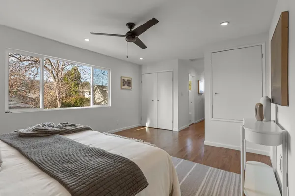 a bedroom with a bed and a large window