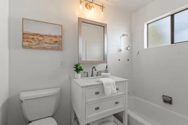 a bathroom with a toilet a sink and a bath tub