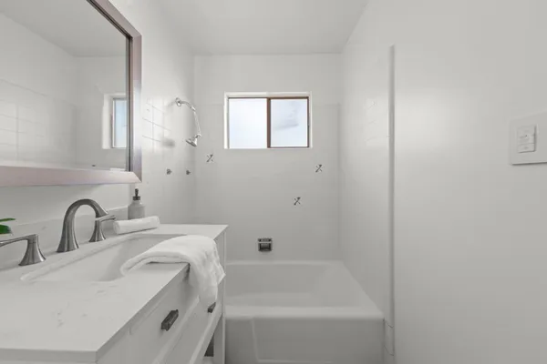 a bathroom with a sink and a bathtub