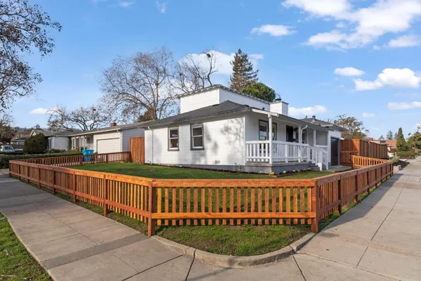 a view of a house with a wooden deck