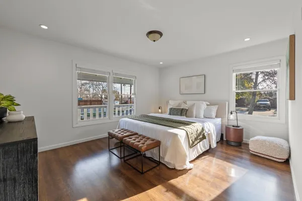 a bed room with a bed and a chair