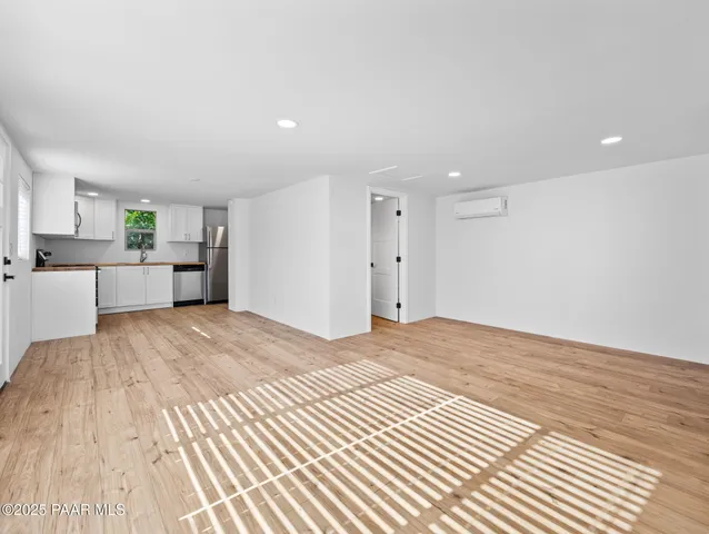 a view of a kitchen with a dishwasher and a refrigerator