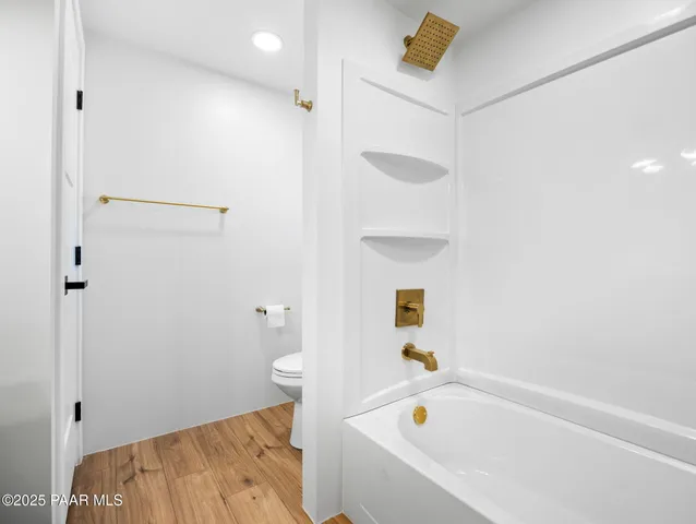 a bathroom with a bathtub and shower