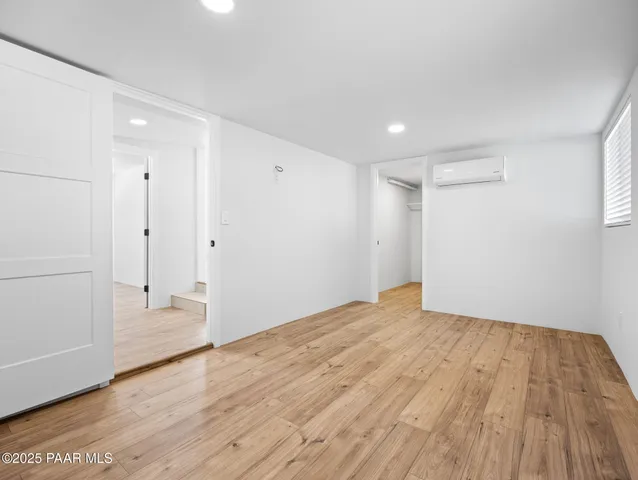 a view of an empty room and wooden floor