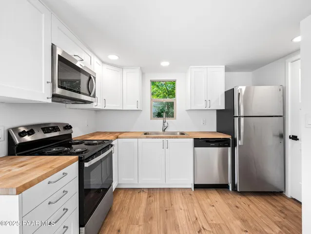 a kitchen with a refrigerator stove and microwave