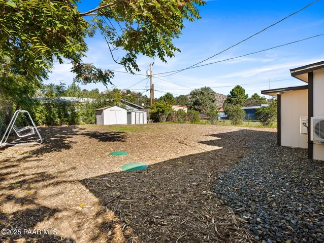 a backyard of a house with large trees