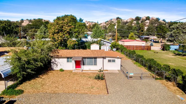 a view of a house with a yard and tree s