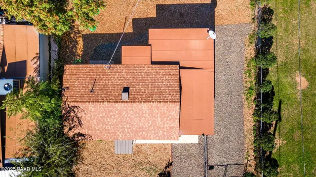 an aerial view of mountains residential house and green space