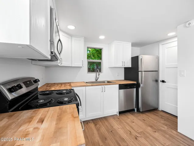 a kitchen with a sink a stove and refrigerator